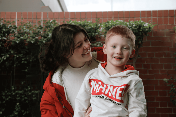 A young boy is with his female disability support worker.